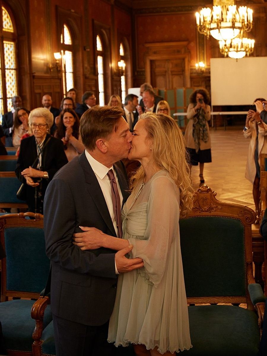 Bride and groom share their first kiss during a Los Angeles wedding ceremony